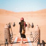 A woman walking on a decorative path in Al Wahat Al Dakhla Desert, Egypt