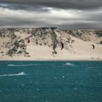 Kitesurfers enjoy the winds off the sandy shores of Laâyoune, Morocco.